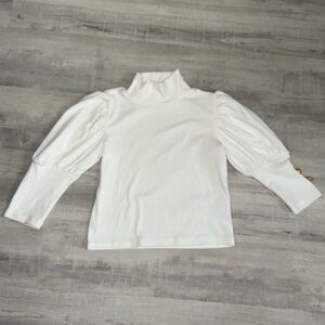 New little girls cream dress shirt with gold button accents. Pullover the head.